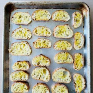 Broil Sliced Baguette Brushed with Olive Oil for 2-3 Minutes