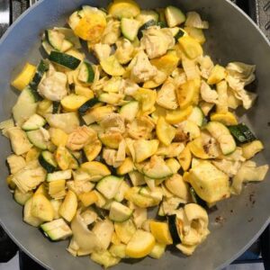 In Separate Skillet Combine Garlic, Zucchini, Squash, Artichokes, and Nature's Seasons