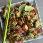Vegan Drunken Noodles Bowl Filled with Rice Noodles, Crisp Tender Vegetables, Tofu, and a Savory Sauce.